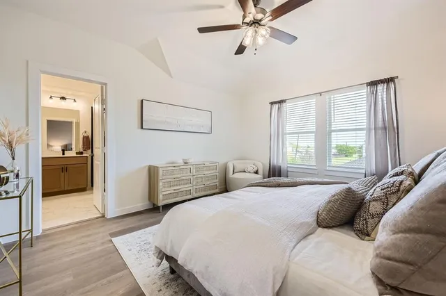 a bedroom with a large bed and a window