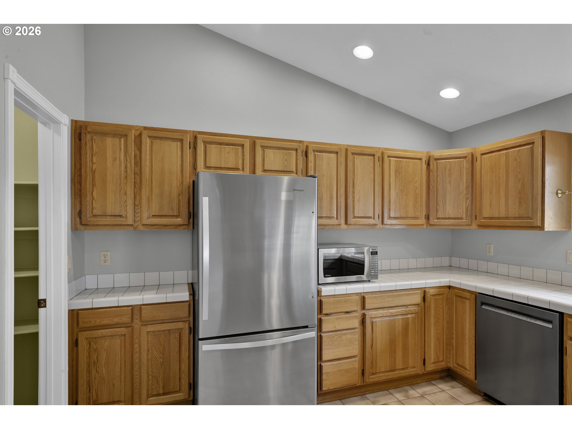 4159 Kurth Street South Salem, OR 97302 - Photo 16 of 37 a kitchen with a refrigerator a sink and cabinets