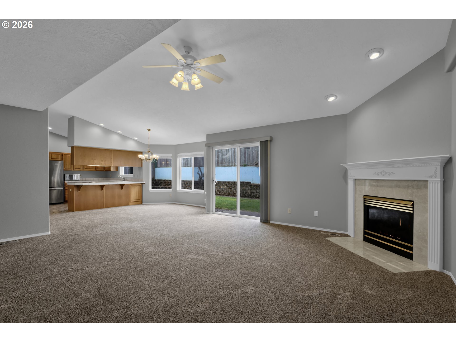 4159 Kurth Street South Salem, OR 97302 - Photo 6 of 37 a view of an empty room with a fireplace and chandelier