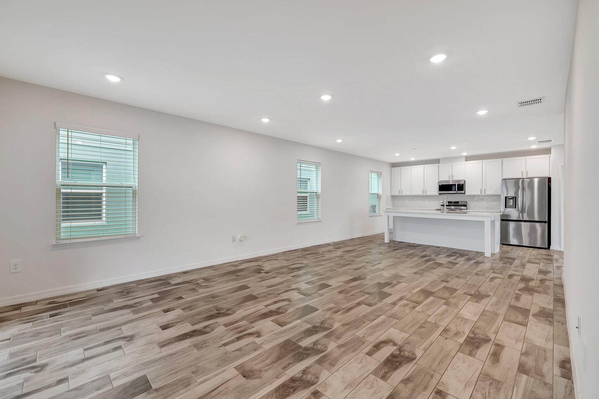 9398 Serapis Way Port St. Lucie, FL 34987 - Photo 11 of 50 a view of kitchen with refrigerator sink and wooden floor