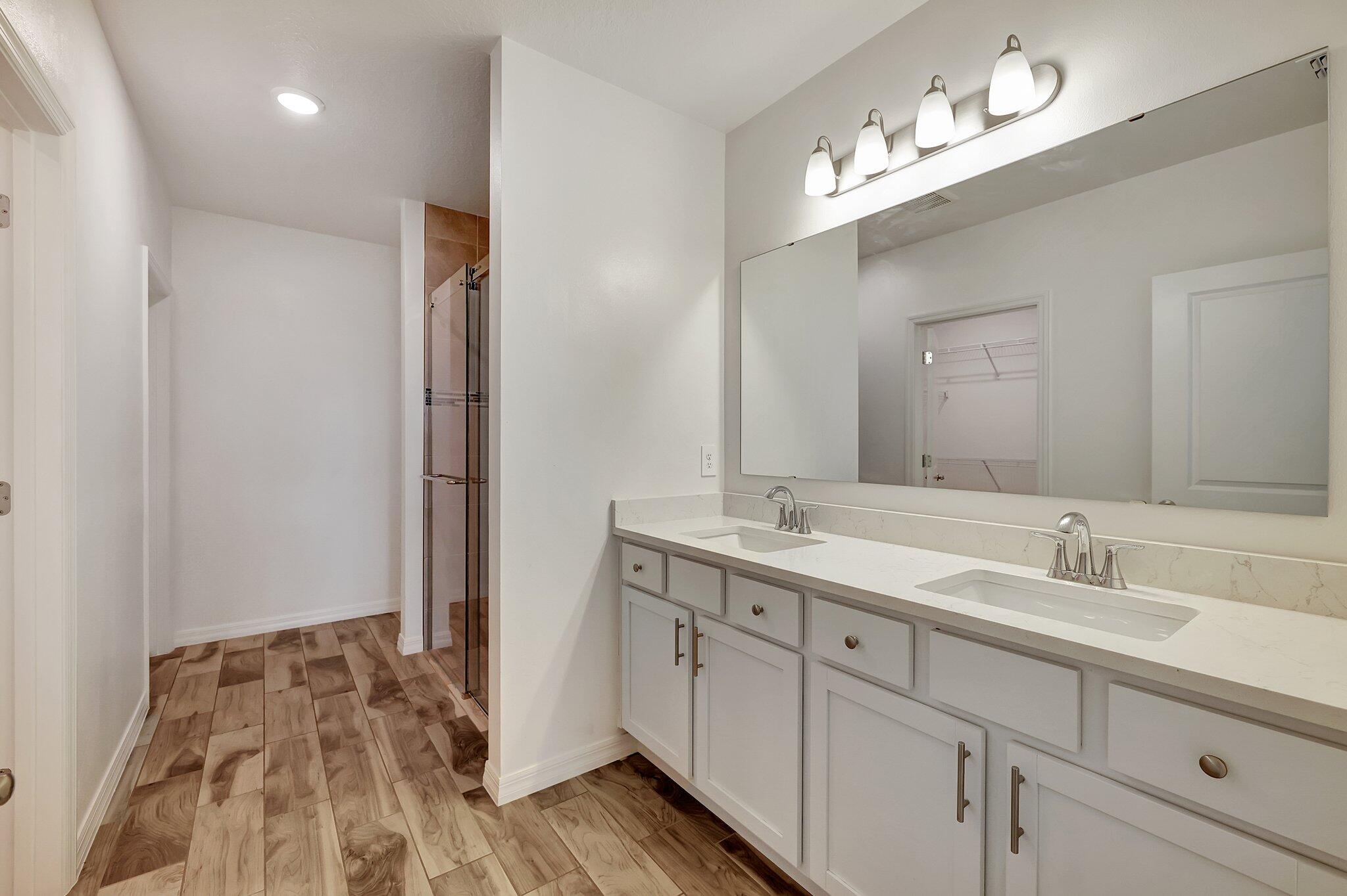 9398 Serapis Way Port St. Lucie, FL 34987 - Photo 18 of 50 a spacious bathroom with a double vanity sink and a mirror