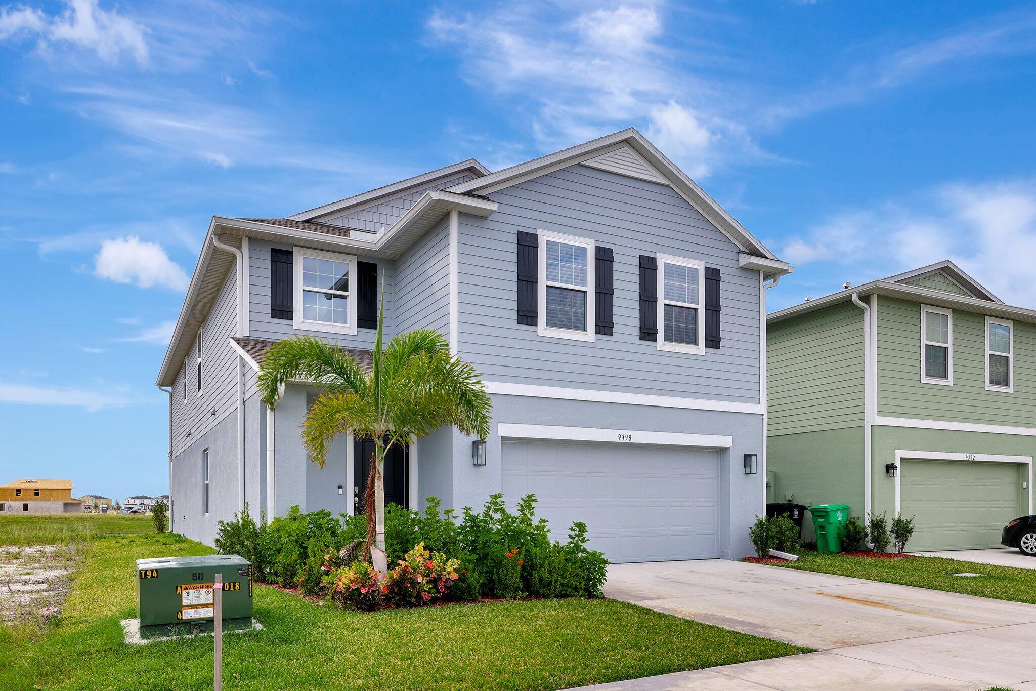 9398 Serapis Way Port St. Lucie, FL 34987 - Photo 2 of 50 a front view of a house with garden