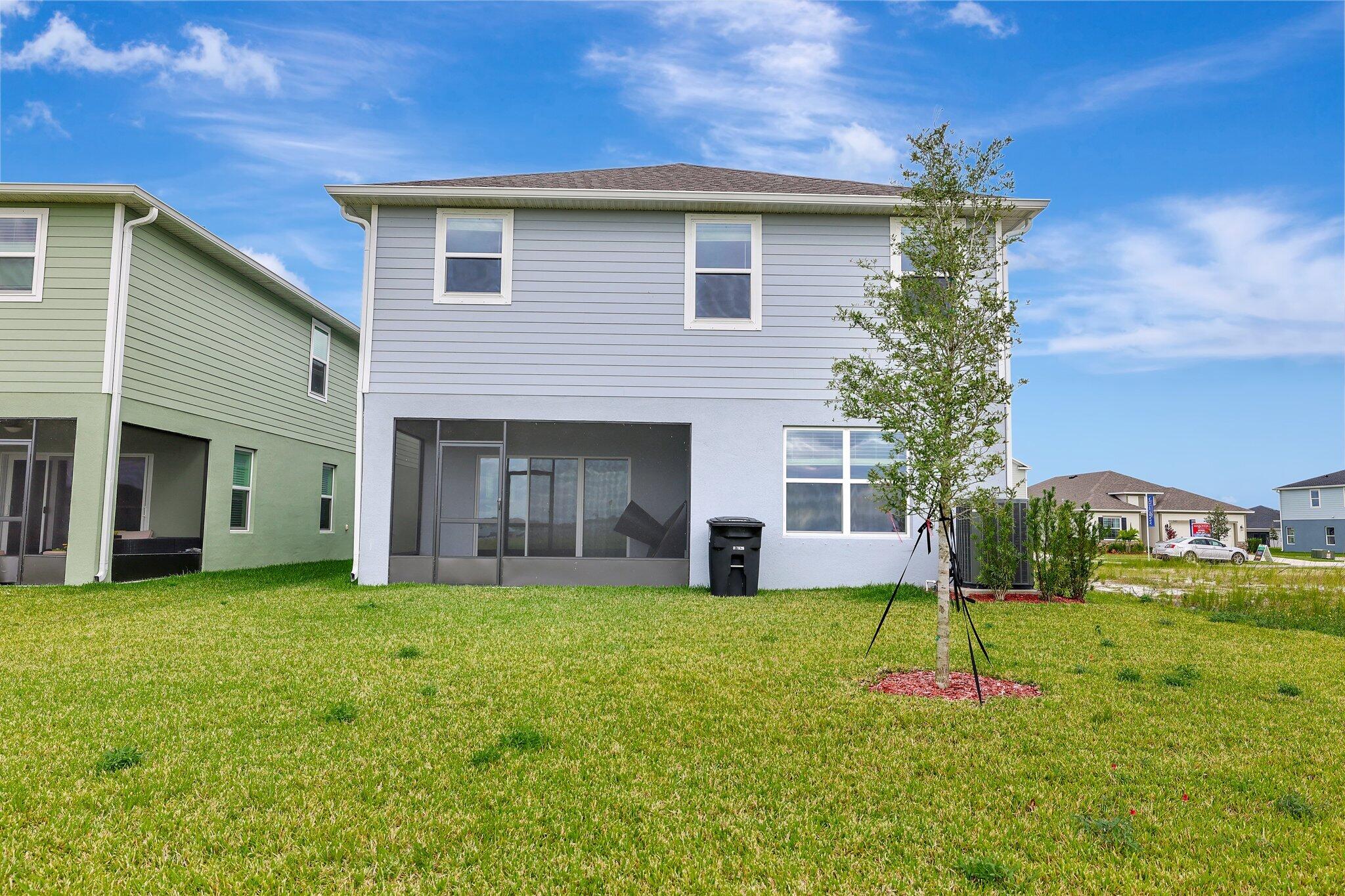 9398 Serapis Way Port St. Lucie, FL 34987 - Photo 4 of 50 a front view of a house with a yard and garage