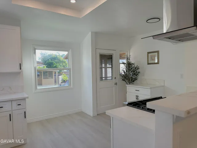 a kitchen with stainless steel appliances a stove sink and cabinets