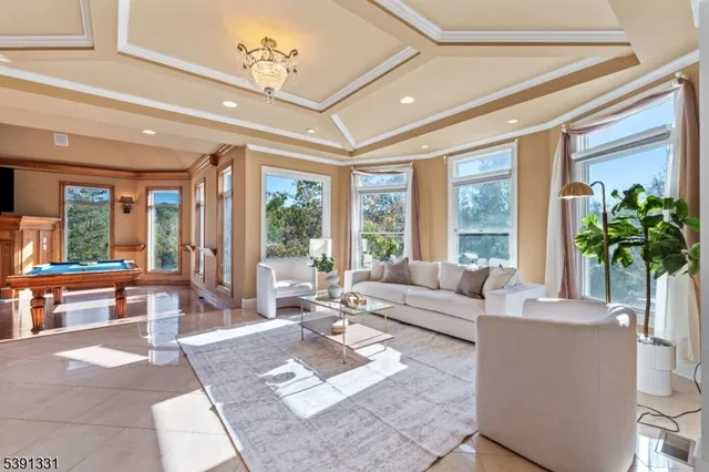 a view of a house with swimming pool lawn chairs and a yard