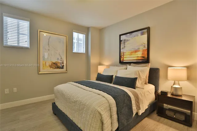 a bedroom with a bed and a painting on the wall