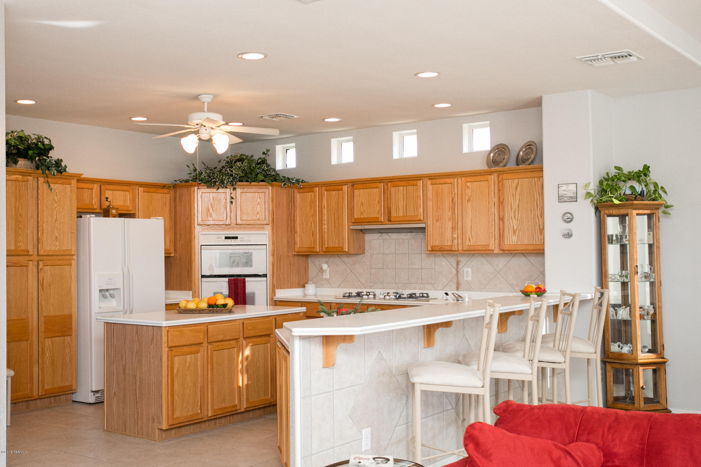 62419 East Northwood Road Tucson, AZ 85739 - Photo 17 of 30 a kitchen with stainless steel appliances kitchen island granite countertop a refrigerator and a stove top oven