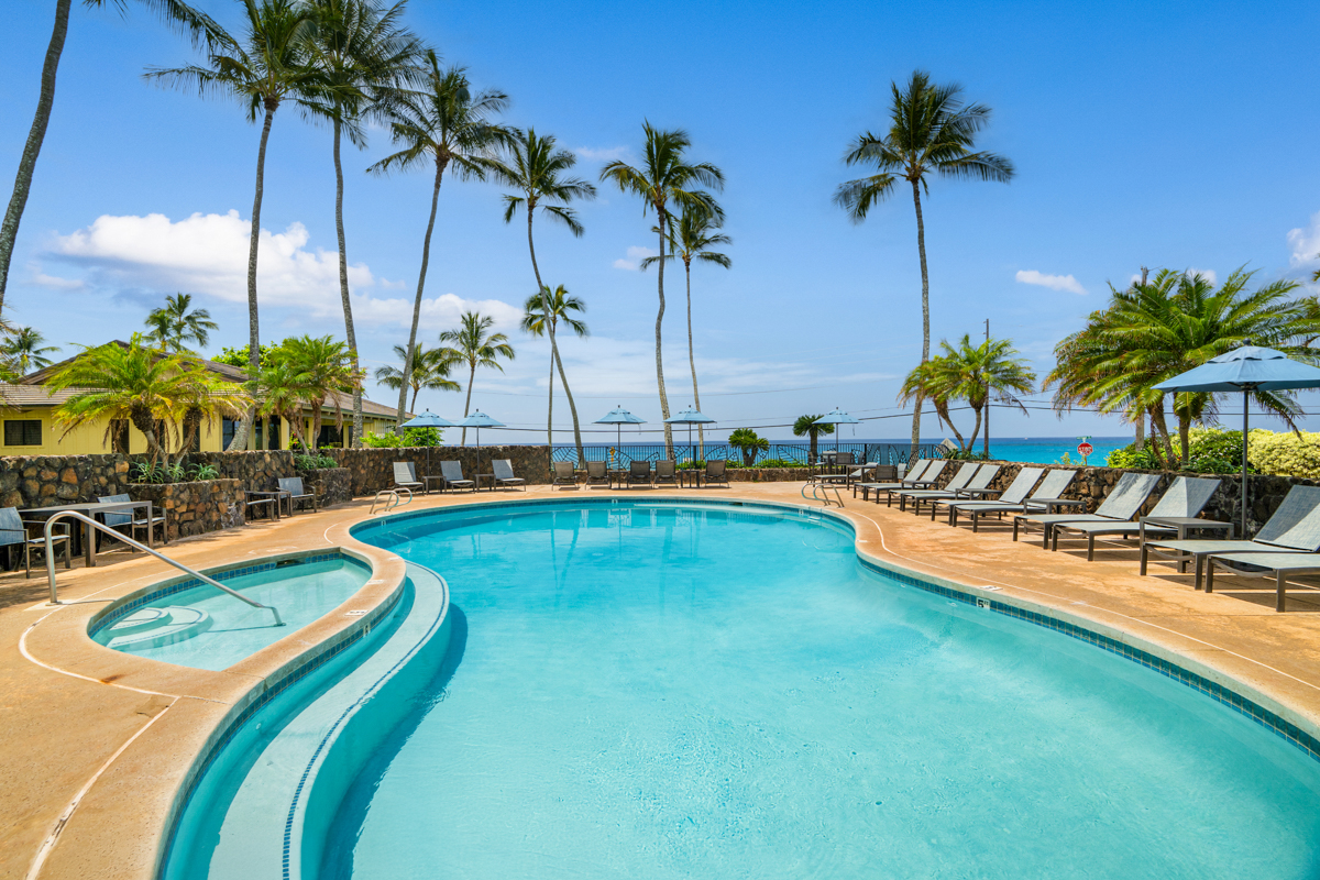 1870 Hoone Road, Unit 602 Koloa, HI 96756 - Photo 12 of 26 a view of a swimming pool with a table and chairs