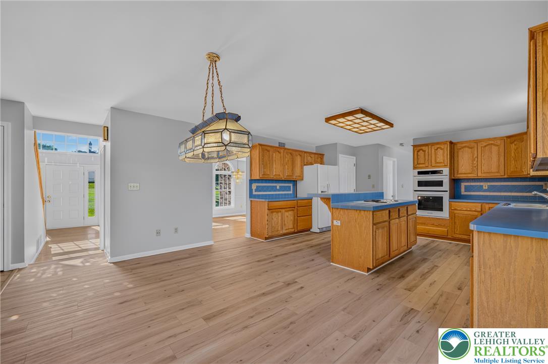 630 Clearfield Road Nazareth, PA 18064 - Photo 30 of 100 Classic oak cabinetry and an expansive central island anchor this open-concept kitchen.