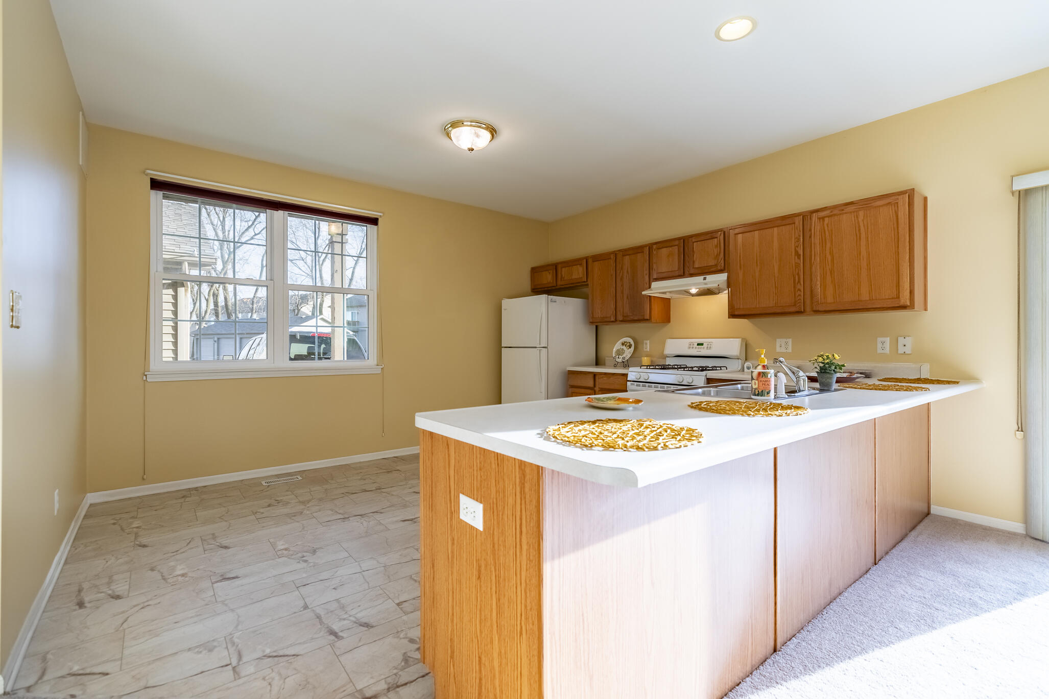 1253 Primrose Lane Schererville, IN 46375 - Photo 8 of 19 a kitchen with stainless steel appliances granite countertop a sink stove and a refrigerator