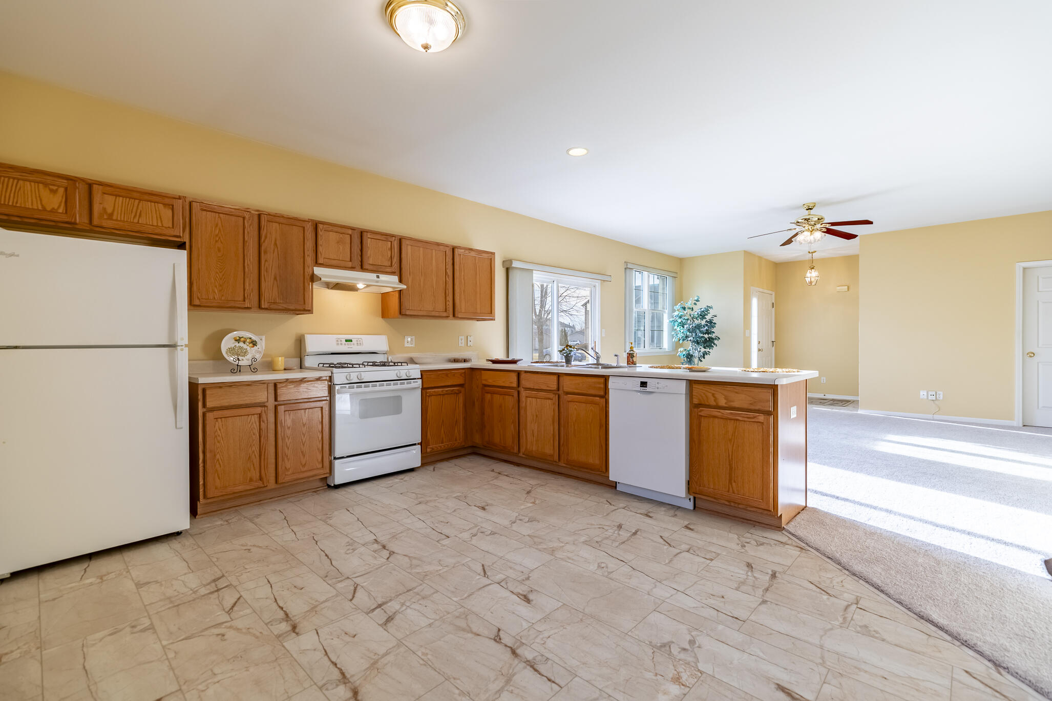 1253 Primrose Lane Schererville, IN 46375 - Photo 10 of 19 a kitchen with a sink a counter top space cabinets and stainless steel appliances