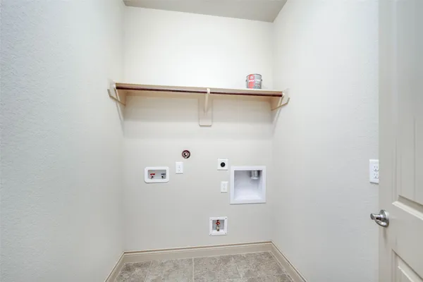 a large kitchen with kitchen island granite countertop a stove a sink and a microwave