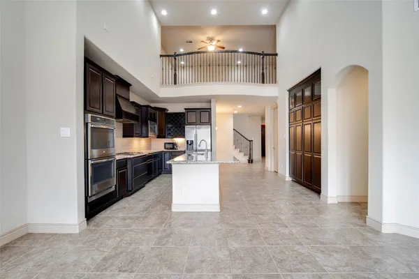 a kitchen with stainless steel appliances granite countertop a sink and a stove