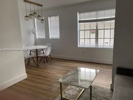 a view of a dining room with furniture and wooden floor