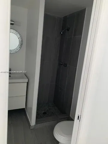 a bathroom with a sink a toilet and vanity