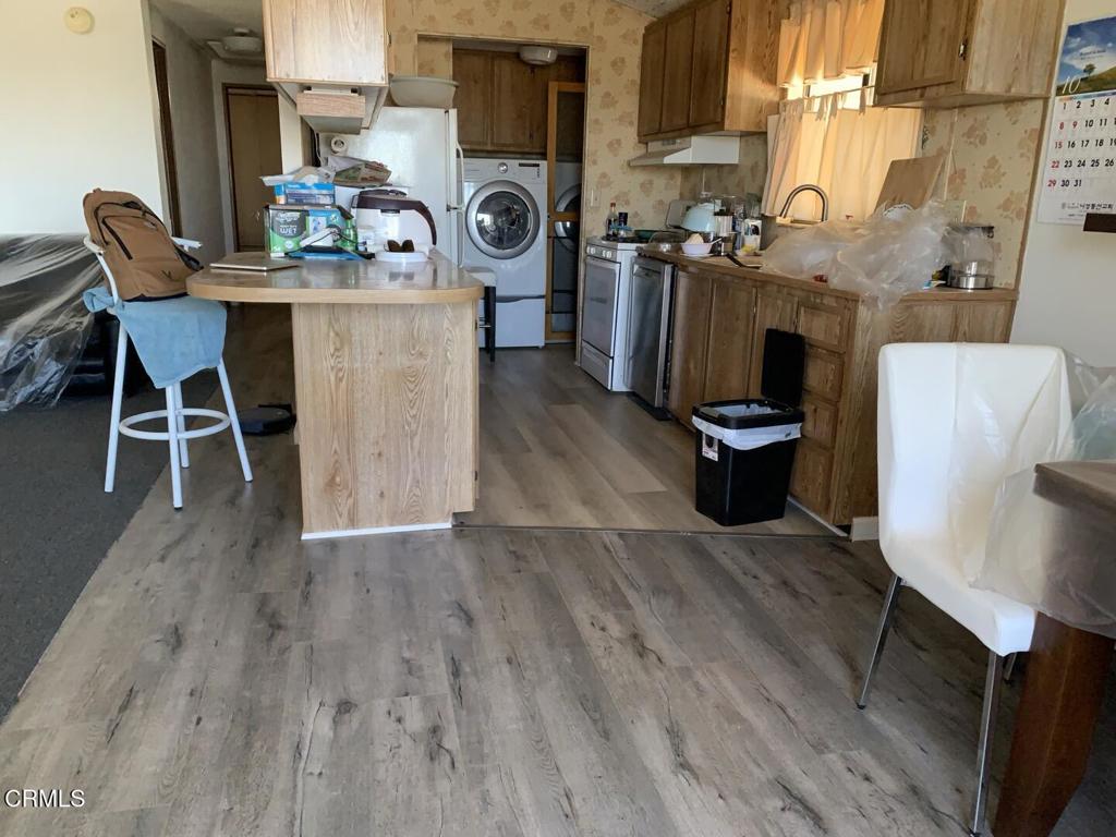 10200 Johnson Road, Unit 52 Phelan, CA 92371 - Photo 11 of 13 a dining room with furniture and wooden floor