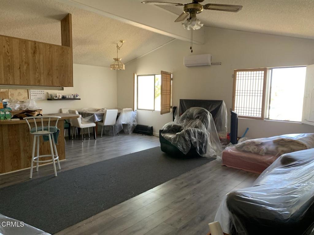 10200 Johnson Road, Unit 52 Phelan, CA 92371 - Photo 12 of 13 a living room with furniture rug and window