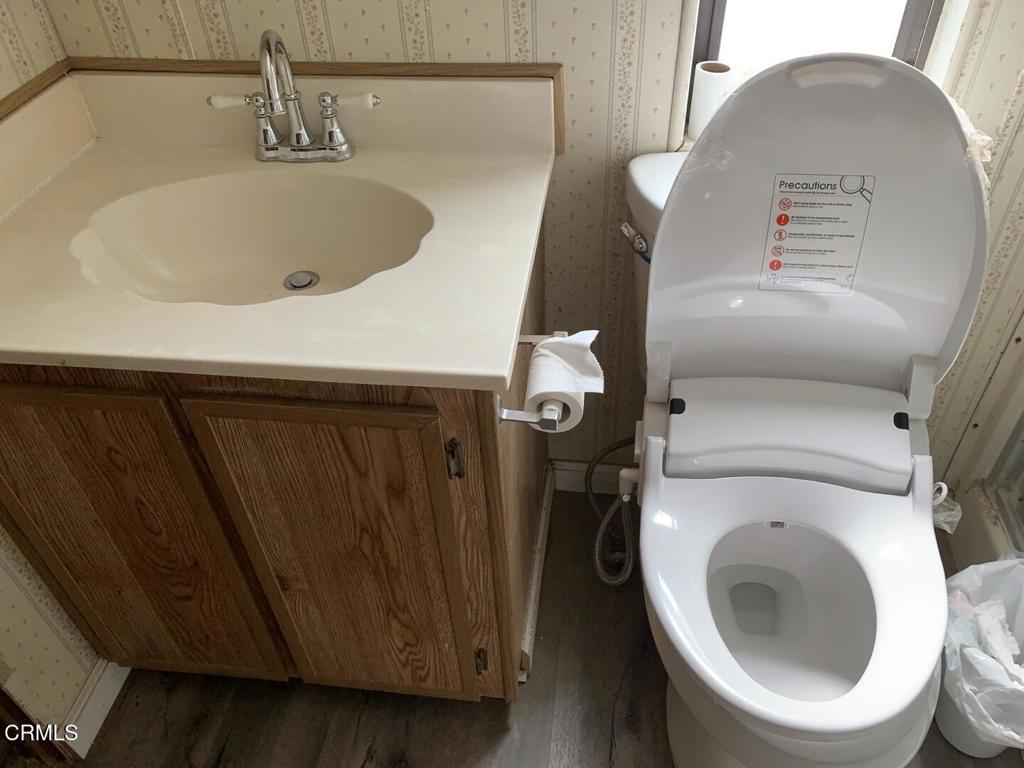 10200 Johnson Road, Unit 52 Phelan, CA 92371 - Photo 3 of 13 a bathroom with a sink and toilet