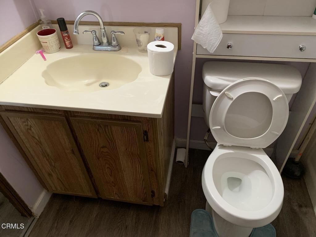 10200 Johnson Road, Unit 52 Phelan, CA 92371 - Photo 4 of 13 a bathroom with a toilet sink and mirror