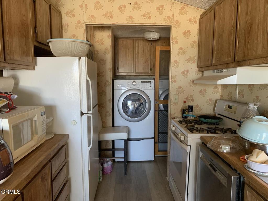 10200 Johnson Road, Unit 52 Phelan, CA 92371 - Photo 5 of 13 a kitchen with a stove and a refrigerator