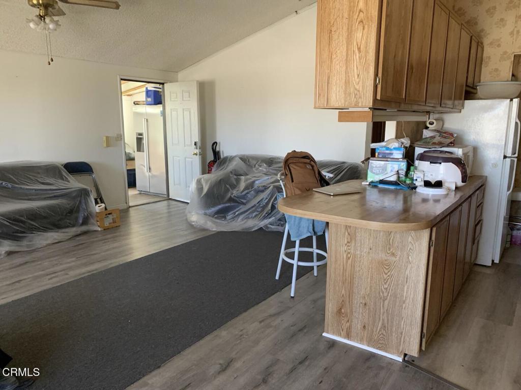 10200 Johnson Road, Unit 52 Phelan, CA 92371 - Photo 8 of 13 a kitchen with furniture a counter space and a sink