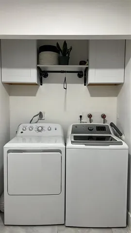 a utility room with dryer and cabinets