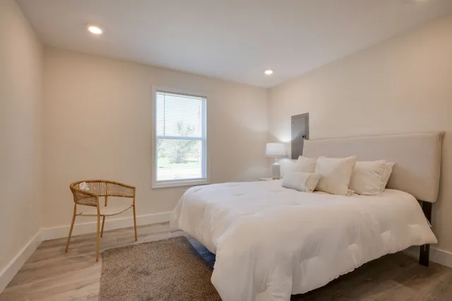 a bedroom with a bed and a night stand