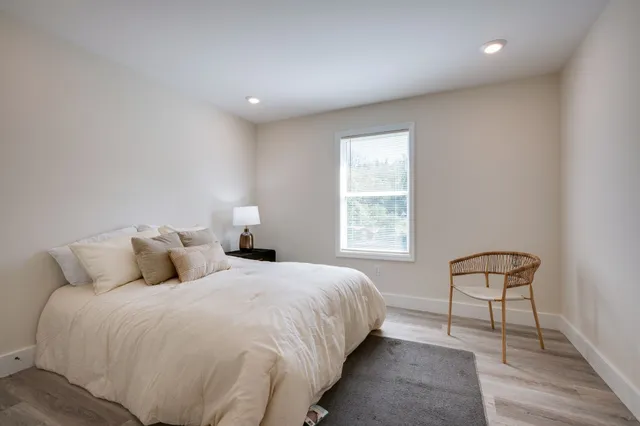 a bedroom with bed and a window