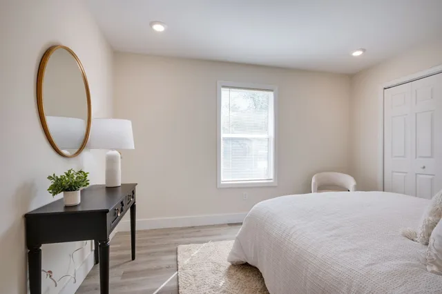 a bedroom with a bed and a lamp