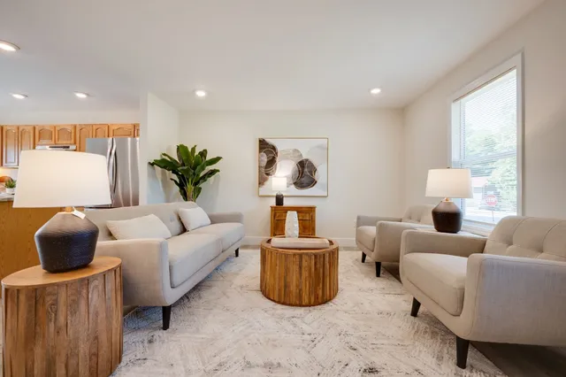 a living room with furniture and a large window