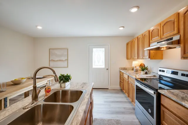 a kitchen with a table chairs refrigerator and cabinets