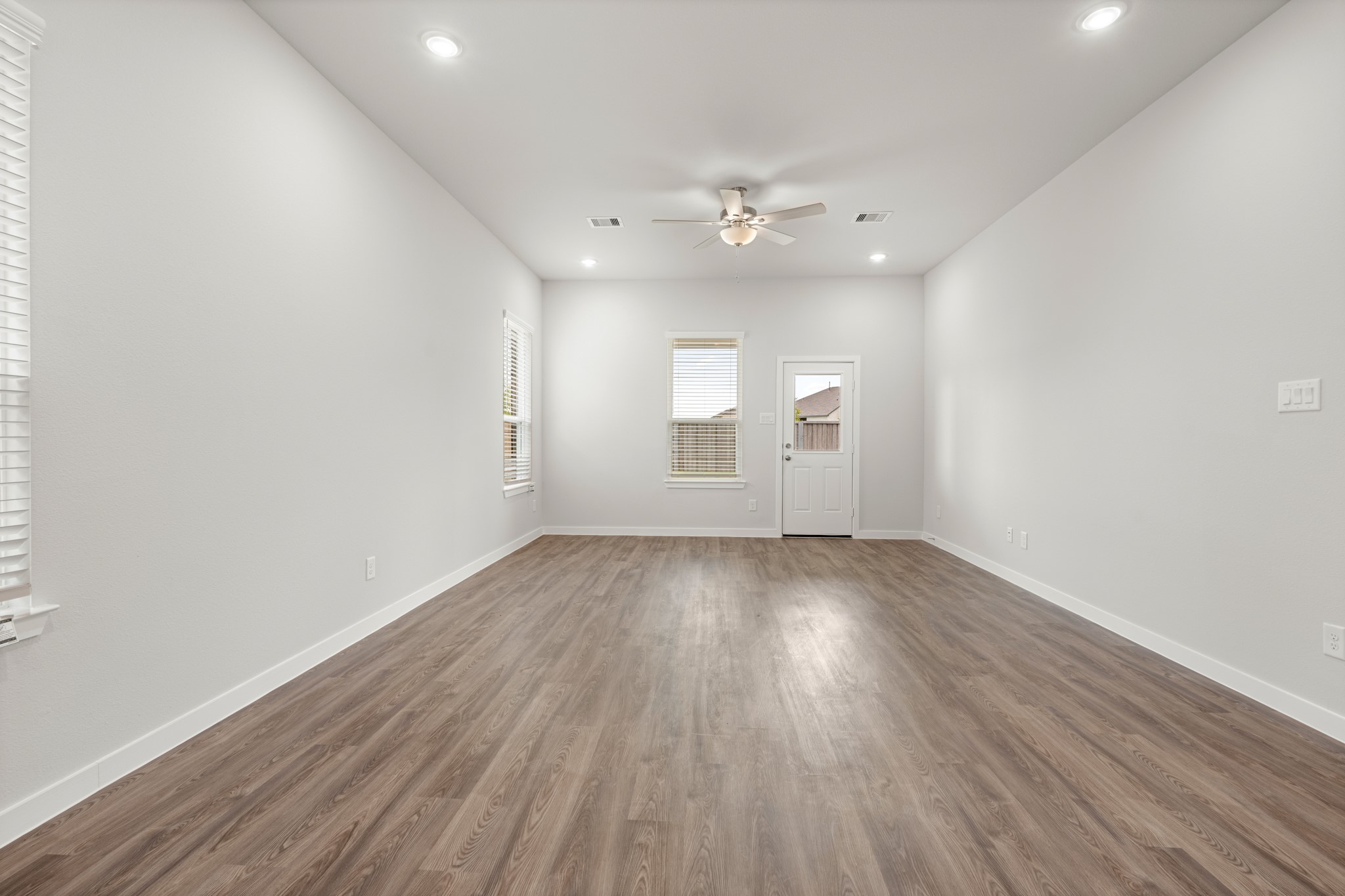 641 Pomegranate Lane La Marque, TX 77568 - Photo 8 of 22 an empty room with wooden floor and windows