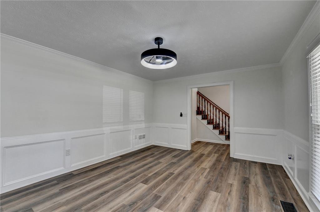 1530 Plunketts Road Buford, GA 30519 - Photo 16 of 54 a view of an empty room with wooden floor and a window