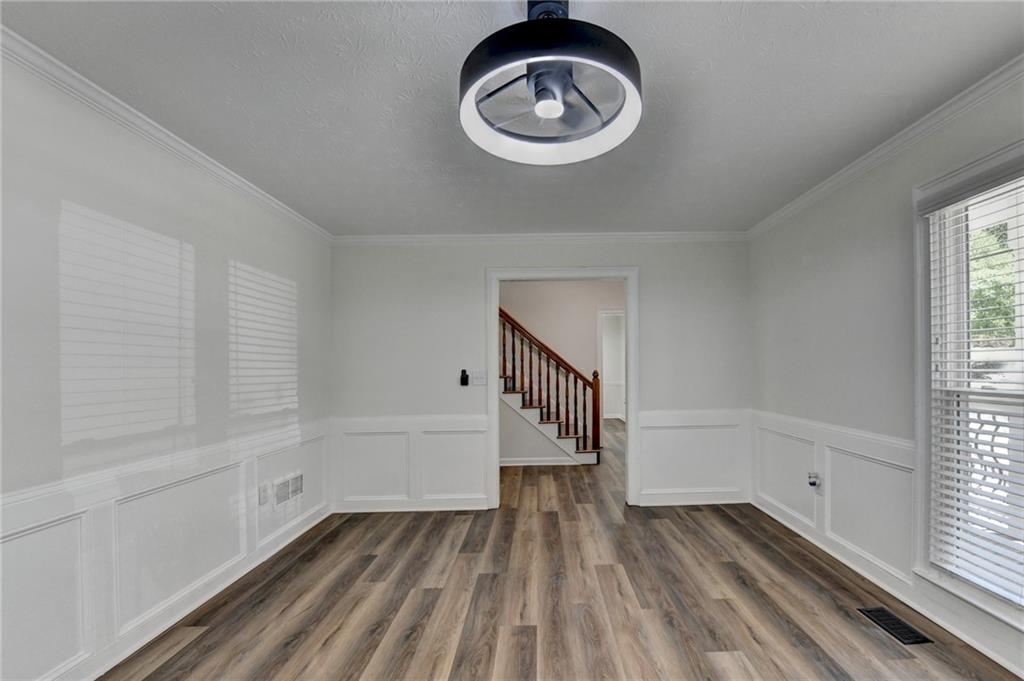 1530 Plunketts Road Buford, GA 30519 - Photo 17 of 54 a view of empty room with wooden floor and window