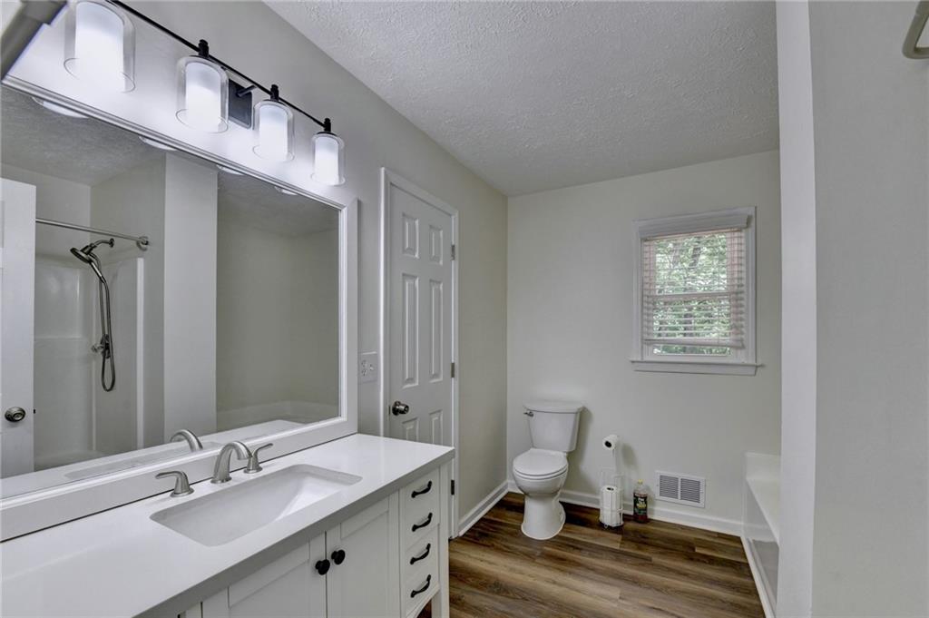 1530 Plunketts Road Buford, GA 30519 - Photo 30 of 54 a bathroom with a sink and a mirror