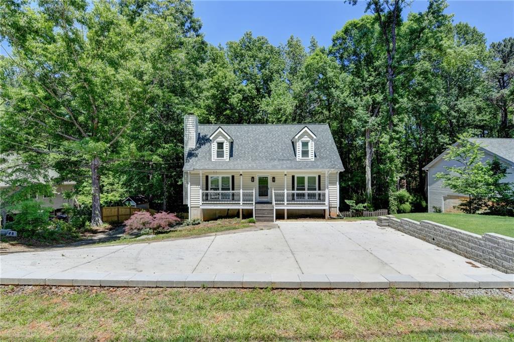 1530 Plunketts Road Buford, GA 30519 - Photo 3 of 54 front view of a house with a yard