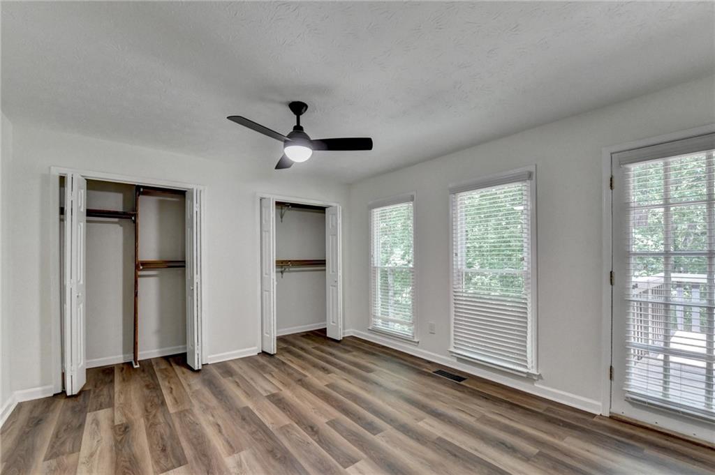1530 Plunketts Road Buford, GA 30519 - Photo 31 of 54 an empty room with wooden floor and windows