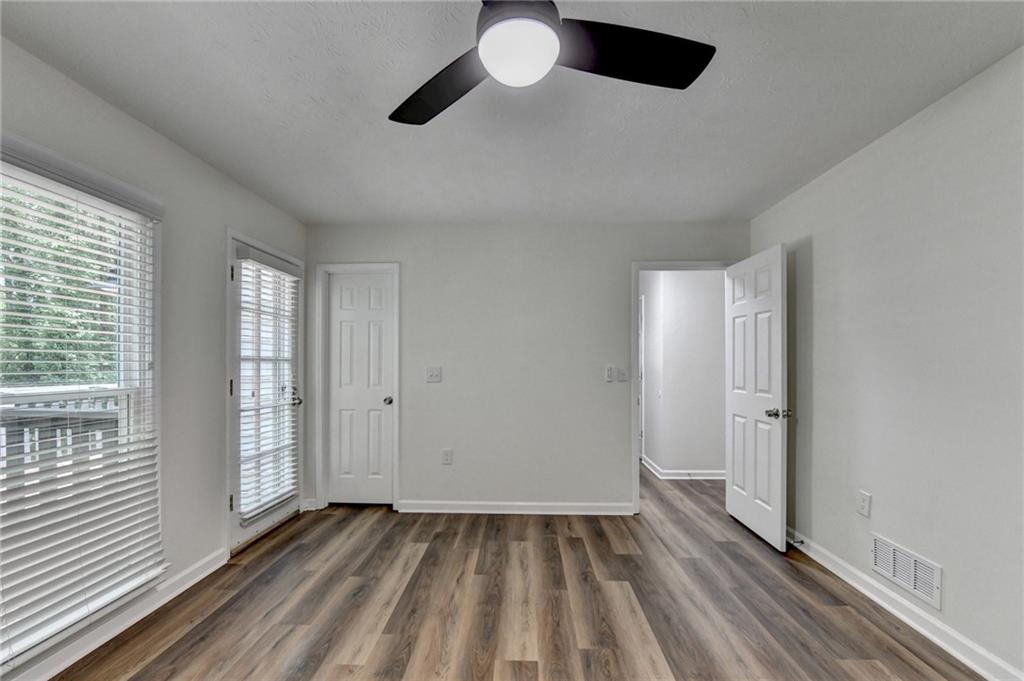1530 Plunketts Road Buford, GA 30519 - Photo 34 of 54 a view of an empty room with wooden floor and a window