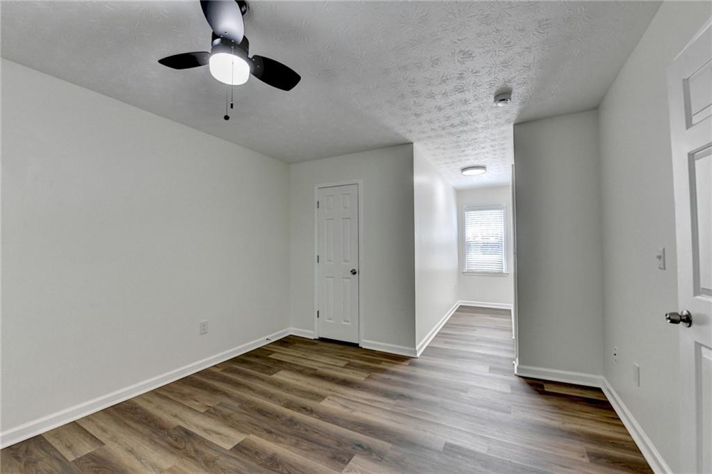 1530 Plunketts Road Buford, GA 30519 - Photo 38 of 54 wooden floor in an empty room with a window