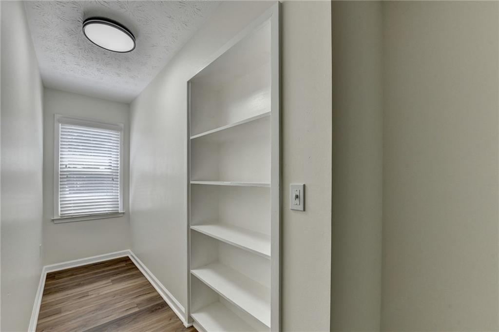 1530 Plunketts Road Buford, GA 30519 - Photo 39 of 54 a view of an empty room with wooden floor and a window
