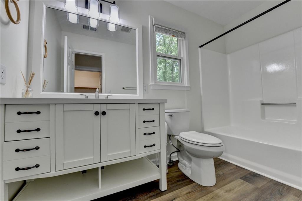 1530 Plunketts Road Buford, GA 30519 - Photo 41 of 54 a bathroom with a sink toilet and window
