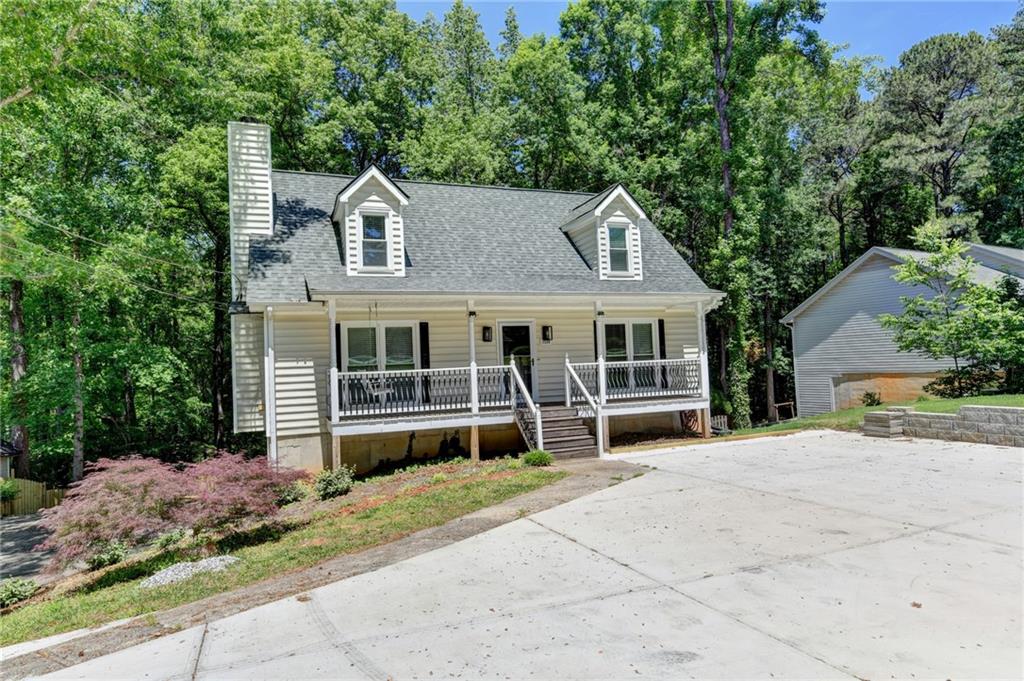 1530 Plunketts Road Buford, GA 30519 - Photo 5 of 54 a front view of a house with a yard and potted plants