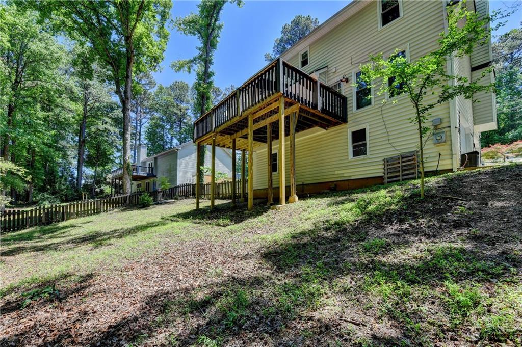 1530 Plunketts Road Buford, GA 30519 - Photo 54 of 54 a backyard of a house with plants and large tree