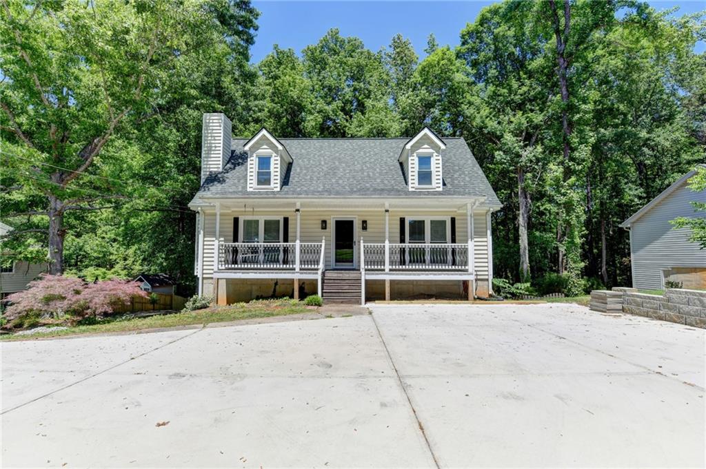1530 Plunketts Road Buford, GA 30519 - Photo 8 of 54 a front view of a house with a garden and trees