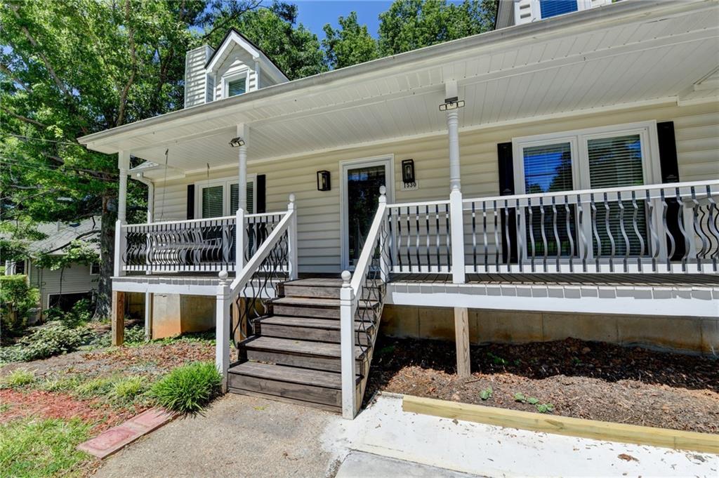 1530 Plunketts Road Buford, GA 30519 - Photo 10 of 54 a view of house with deck and yard