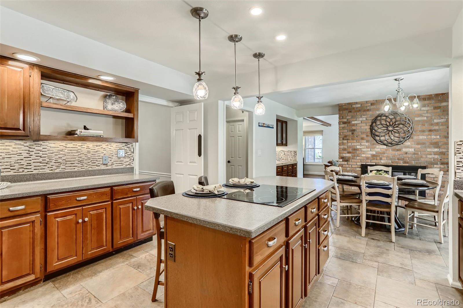 2185 Thistle Ridge Circle Highlands Ranch, CO 80126 - Photo 11 of 37 a kitchen with stainless steel appliances granite countertop a sink and a refrigerator