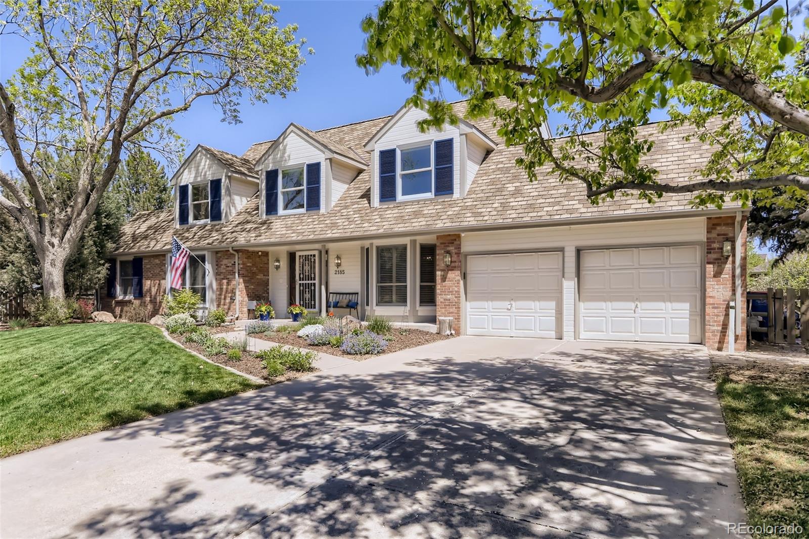 2185 Thistle Ridge Circle Highlands Ranch, CO 80126 - Photo 2 of 37 a front view of a house with a yard and porch
