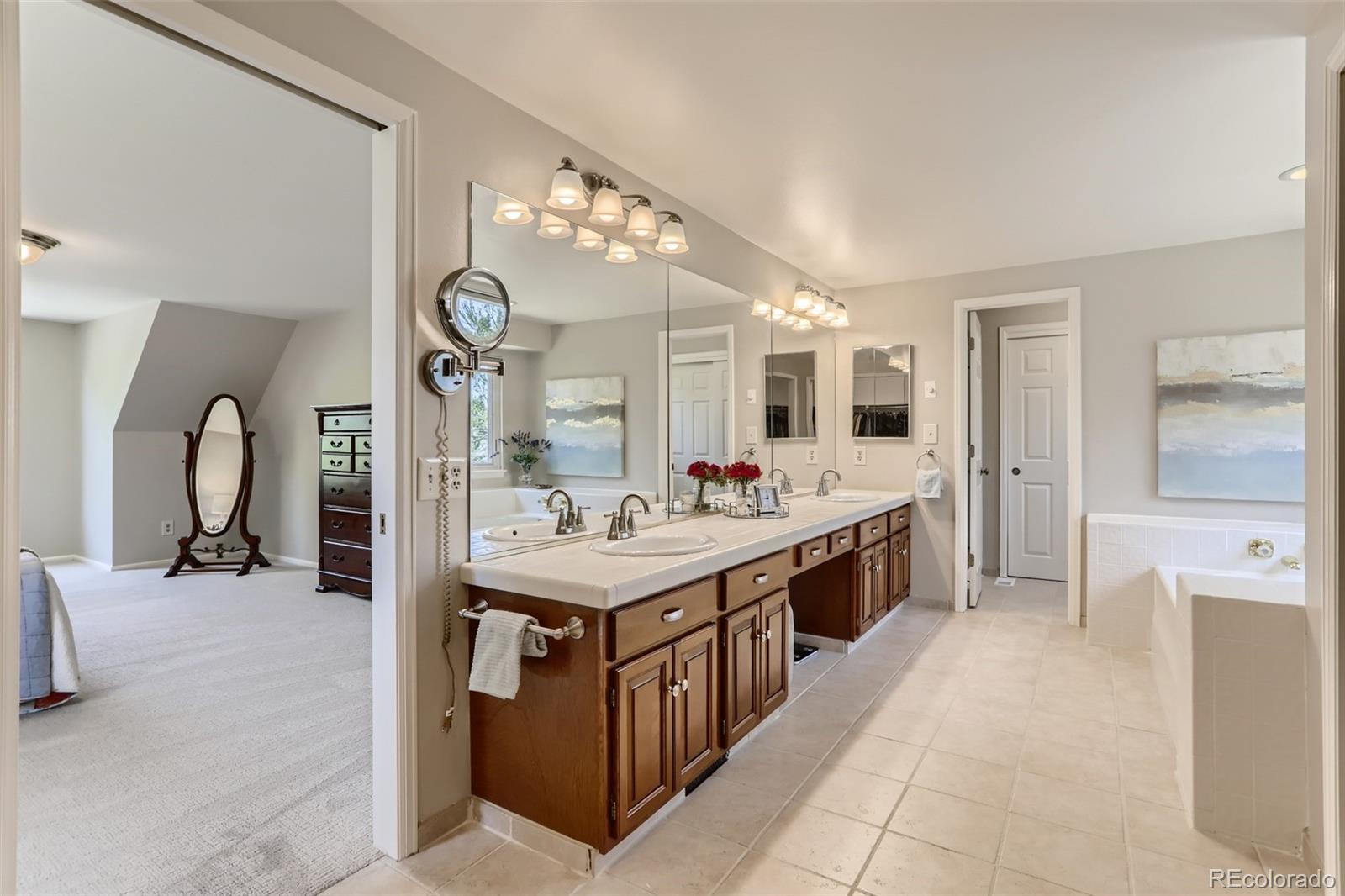 2185 Thistle Ridge Circle Highlands Ranch, CO 80126 - Photo 21 of 37 a large bathroom with a double vanity sink and a mirror