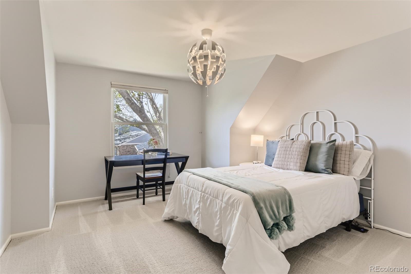 2185 Thistle Ridge Circle Highlands Ranch, CO 80126 - Photo 29 of 37 a bedroom with a bed table and chair