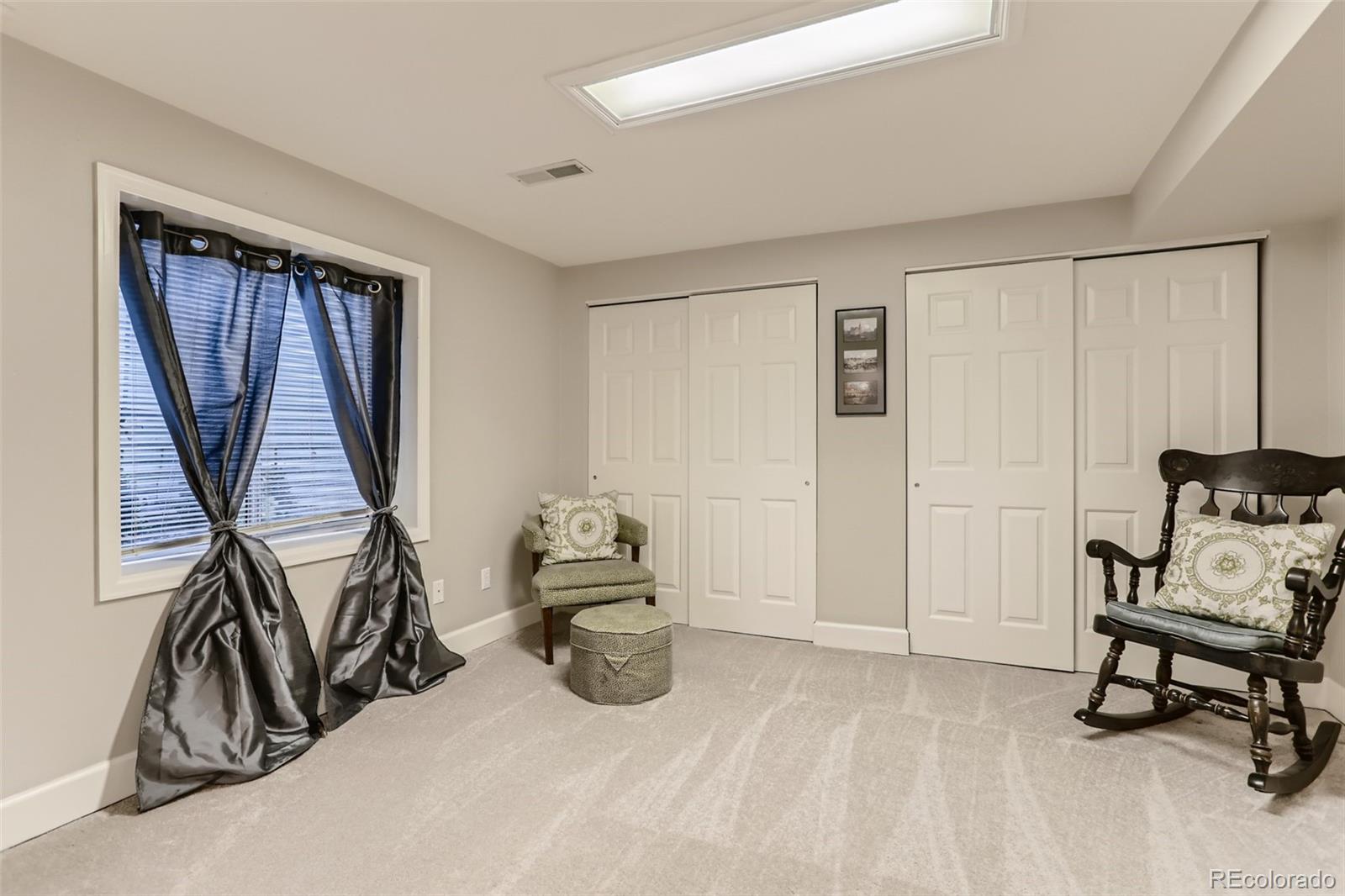 2185 Thistle Ridge Circle Highlands Ranch, CO 80126 - Photo 32 of 37 a bedroom with furniture and a window